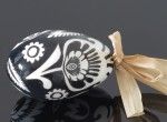 Black decorated egg with a black and white flower (created on a goose eggshell)