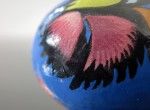 Black decorated egg with a blue cock (created on a goose eggshell)