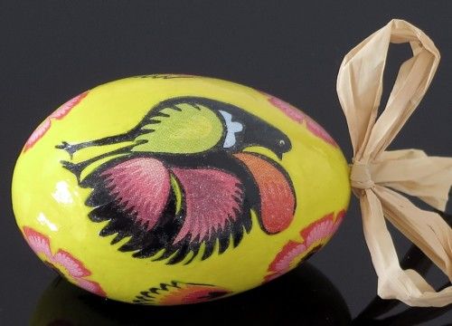 Black decorated egg with a yellow cock (created on a goose eggshell)
