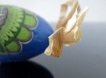 Blue decorated egg with a green flower (created on a goose eggshell)
