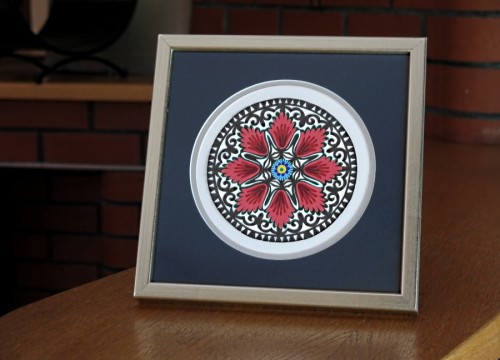 A Łowicz star in a silvery frame (in a navy passe - partout)ower)